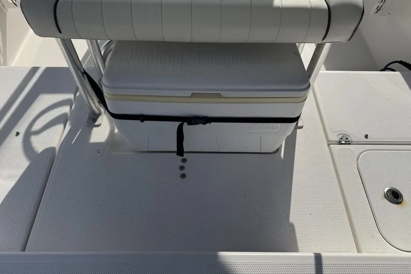 Slide: The Image of 2020 Yamaha Boats 210 FSH Sport deck with cooler and seating area. - 36
