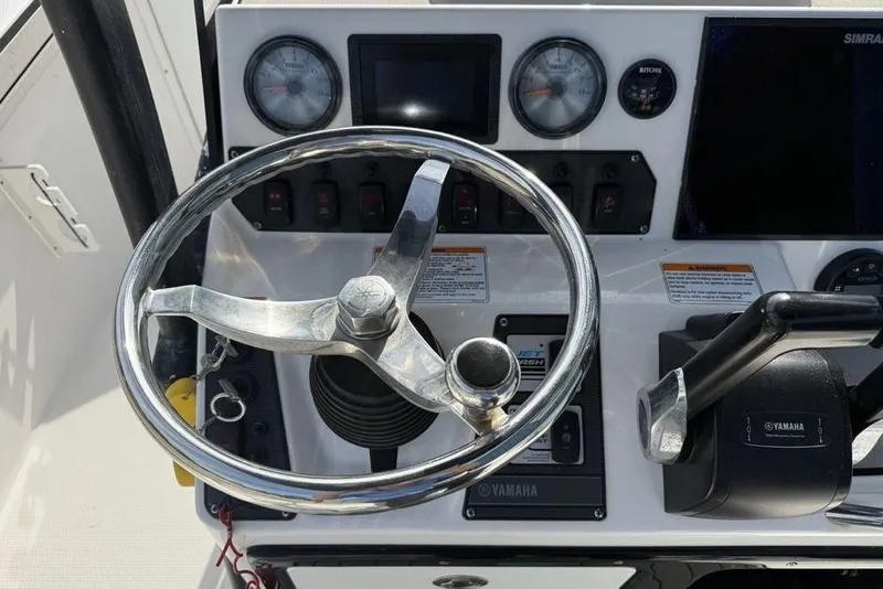 Slide: The Image of Steering console of 2020 Yamaha Boats 210 FSH Sport with gauges and controls. - 38