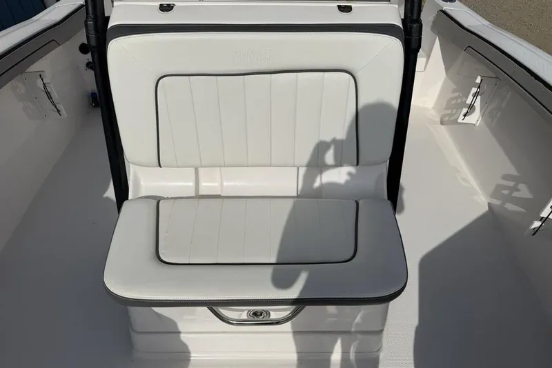 Slide: The Image of 2020 Yamaha Boats 210 FSH Sport interior seating with white upholstery and shadow. - 5