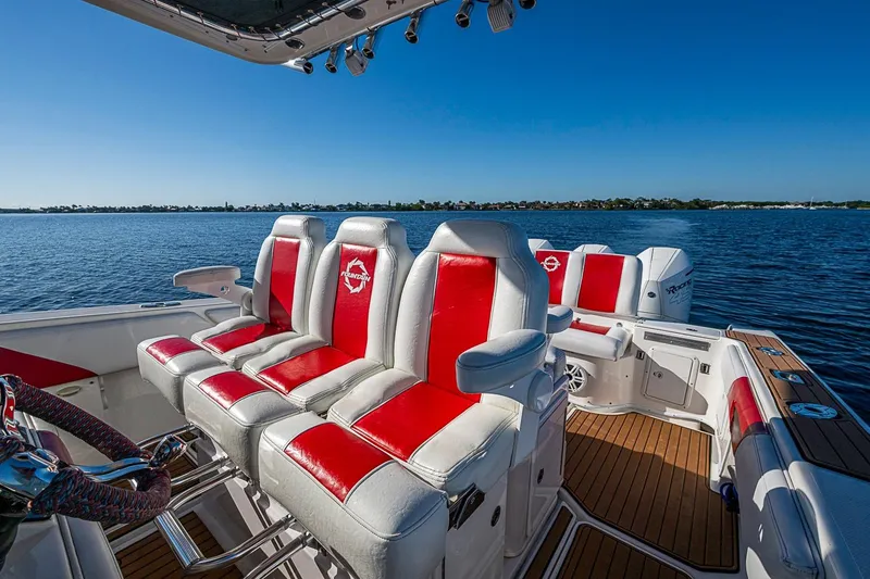 Slide: The Image of 2009 Fountain 38 Center Console boat with red and white seating on a sunny day. - 10