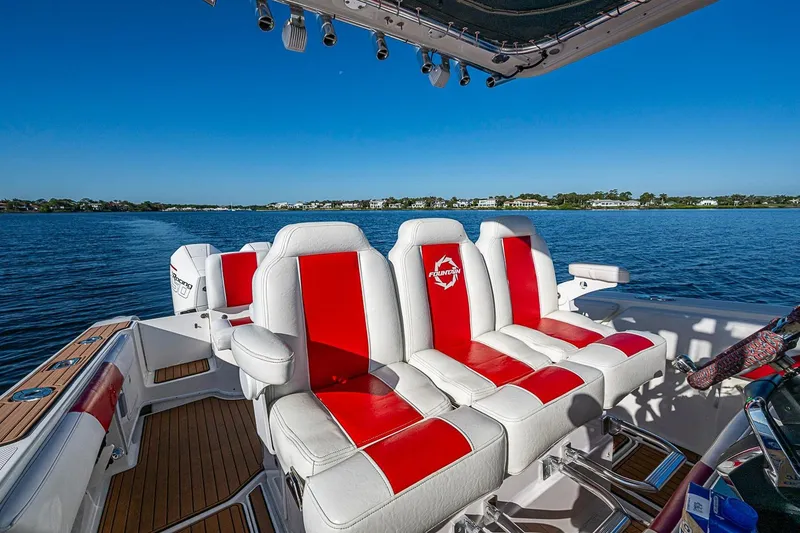 Slide: The Image of 2009 Fountain 38 Center Console boat with red and white seating on a sunny day. - 11