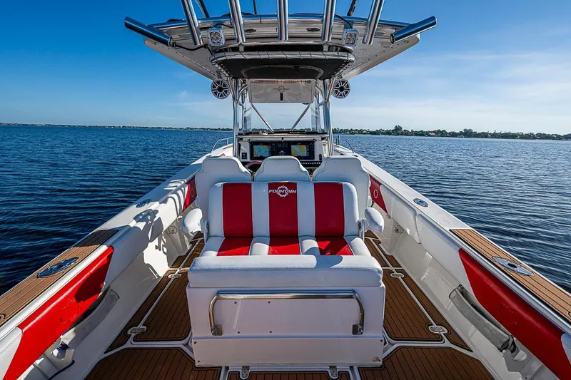 Slide: The Image of 2009 Fountain 38 Center Console boat with red and white seating on open water. - 12