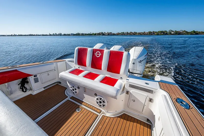 Slide: The Image of 2009 Fountain 38 Center Console boat with red and white seating on open water. - 14