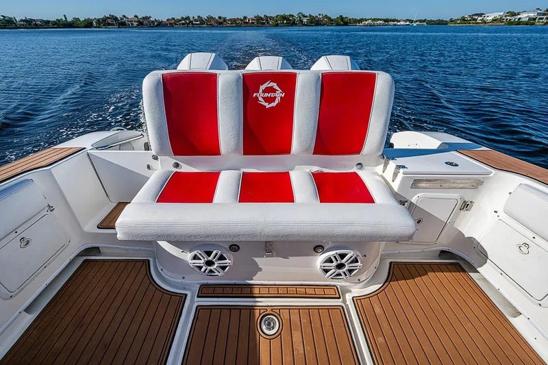 Slide: The Image of 2009 Fountain 38 Center Console boat with red and white seating on a sunny day. - 15
