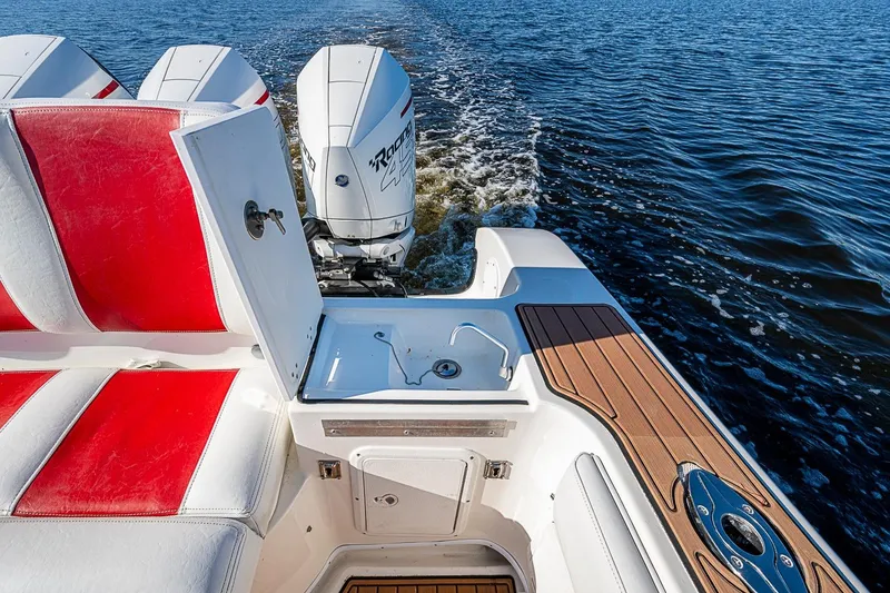 Slide: The Image of 2009 Fountain 38 Center Console boat with red seats and twin outboard motors on water. - 16