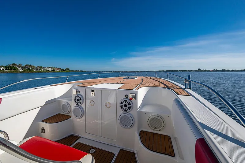 Slide: The Image of 2009 Fountain 38 Center Console boat on calm water, featuring sleek deck design. - 18