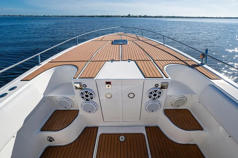 Slide: The Image of 2009 Fountain 38 Center Console boat with teak deck, cruising on open water. - 19