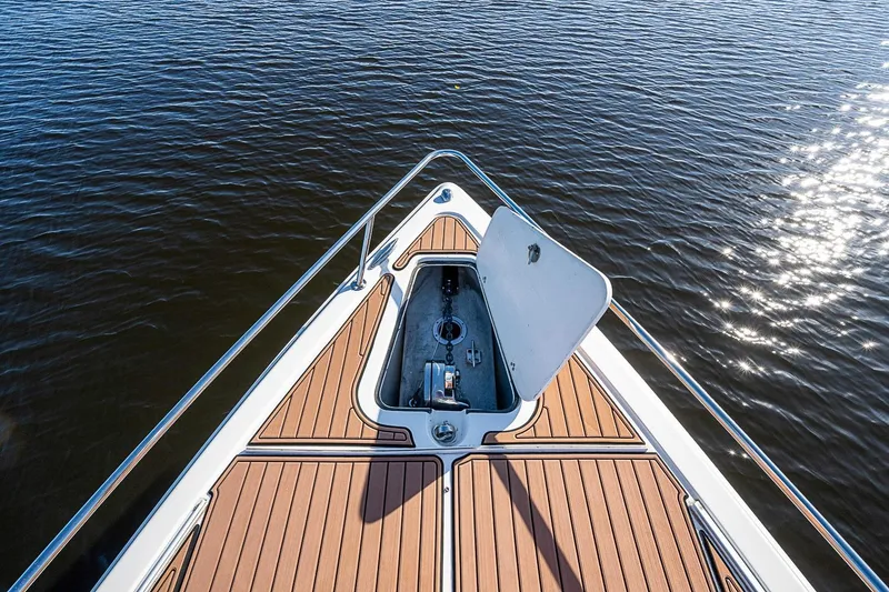 Slide: The Image of 2009 Fountain 38 Center Console boat deck with open hatch on calm water. - 20