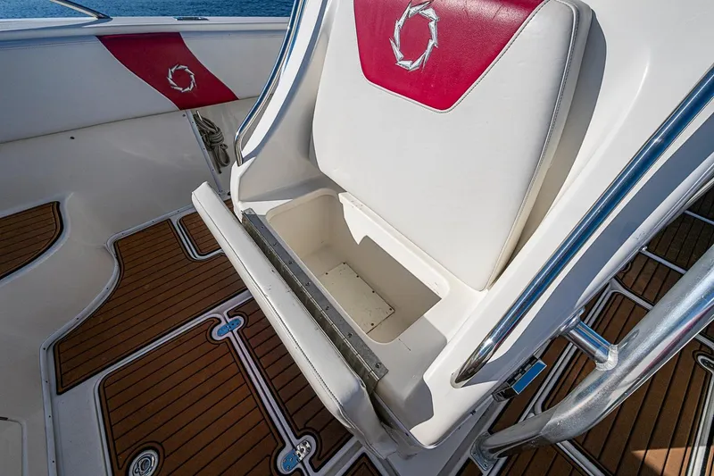 Slide: The Image of 2009 Fountain 38 Center Console boat interior with white and red seating, wooden flooring. - 23