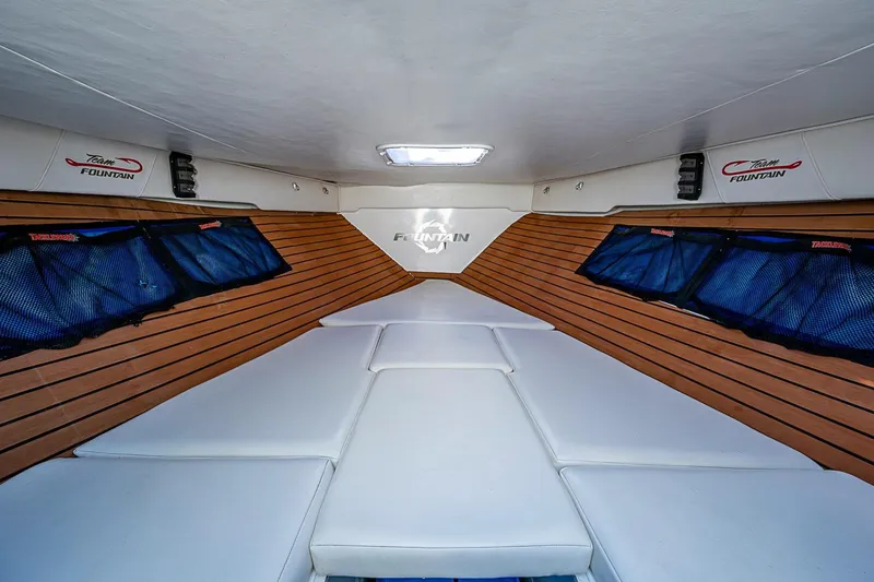 Slide: The Image of Interior cabin of 2009 Fountain 38 Center Console boat with wood paneling and cushioned seating. - 25