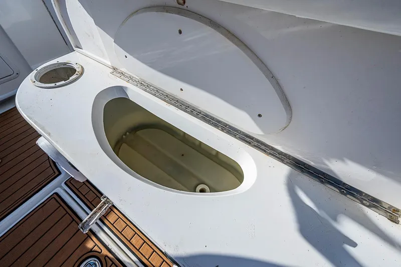 Slide: The Image of Open storage compartment on 2009 Fountain 38 Center Console boat deck. - 27