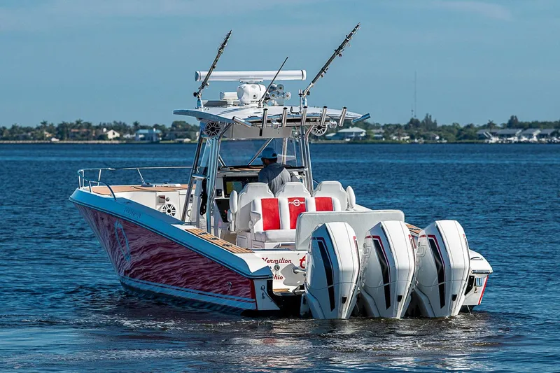 Slide: The Image of 2009 Fountain 38 Center Console boat with triple outboard engines on open water. - 29