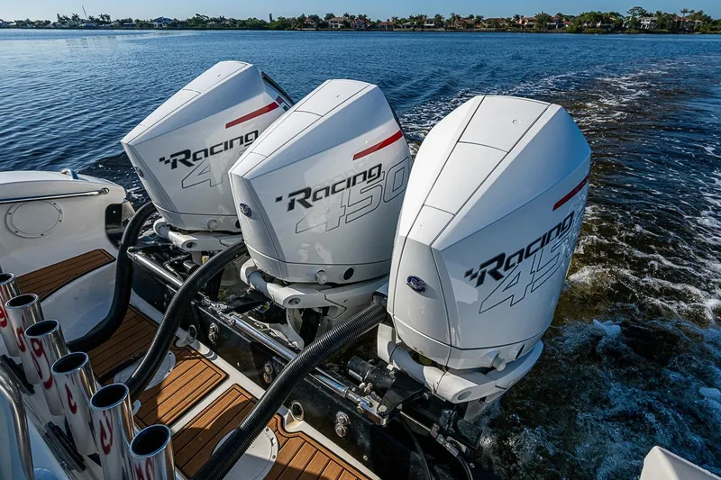 Slide: The Image of Triple outboard engines on a 2009 Fountain 38 Center Console boat, cruising on water. - 30
