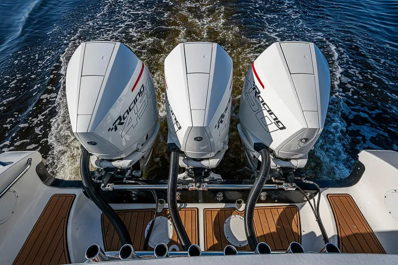 Slide: The Image of Triple outboard engines on a 2009 Fountain 38 Center Console boat in motion. - 31