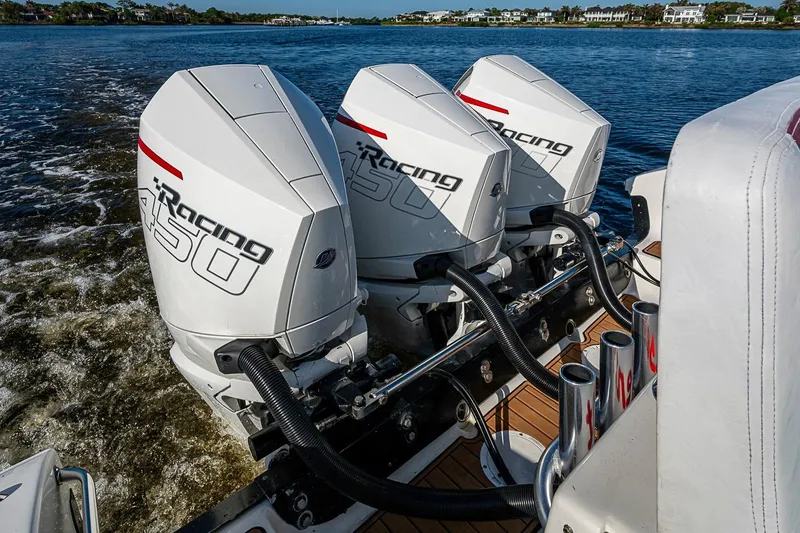 Slide: The Image of Triple outboard engines on a 2009 Fountain 38 Center Console boat, cruising on water. - 32