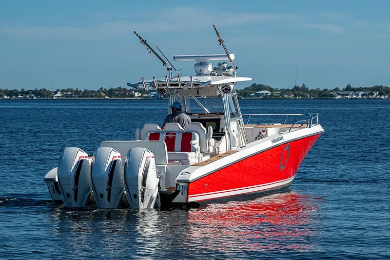 Slide: The Image of 2009 Fountain 38 Center Console boat with triple engines on calm water. - 5