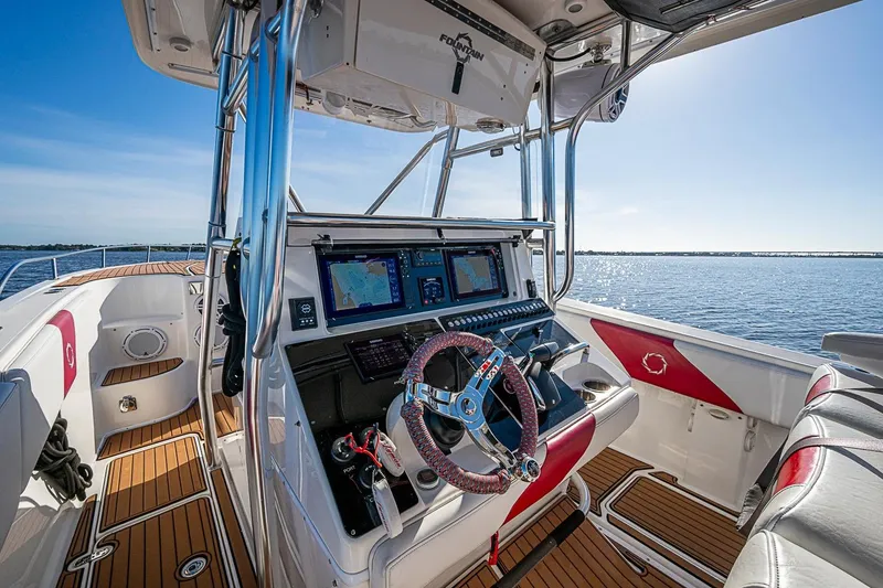 Slide: The Image of 2009 Fountain 38 Center Console boat interior with advanced navigation system on open water. - 7