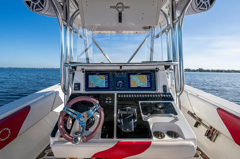 Slide: The Image of 2009 Fountain 38 Center Console boat dashboard with navigation screens on open water. - 8