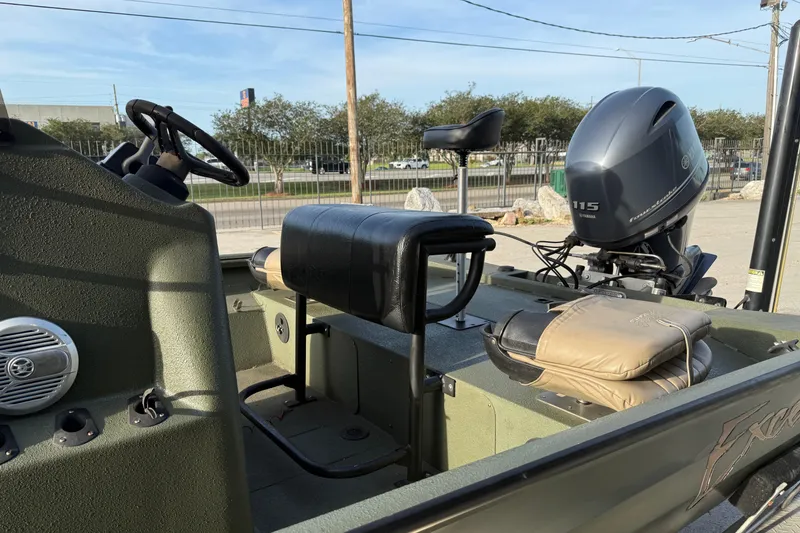 Slide: The Image of 2014 Excel 203 Bay Pro boat interior with Yamaha 115 outboard motor, steering wheel, and seating. - 9
