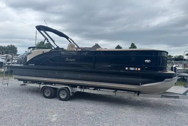 The Image of 2020 Barletta Lusso 25QCSS pontoon boat on trailer, parked on gravel lot. - 1