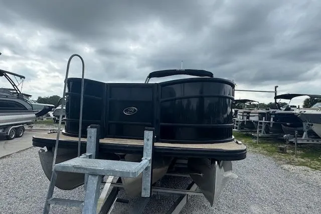 Slide: The Image of 2020 Barletta Lusso 25QCSS pontoon boat on trailer under cloudy sky. - 10