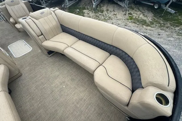 Slide: The Image of 2020 Barletta Lusso 25QCSS boat interior with beige seating and cup holder. - 12