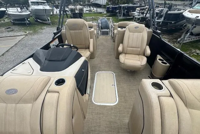 Slide: The Image of 2020 Barletta Lusso 25QCSS pontoon boat interior with beige seating and helm. - 14
