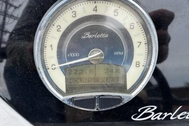 Slide: The Image of Close-up of Barletta Lusso 25QCSS 2020 RPM gauge displaying hours and fuel levels. - 19