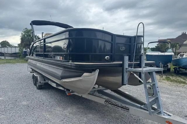 Slide: The Image of 2020 Barletta Lusso 25QCSS pontoon boat on trailer, parked outdoors. - 3