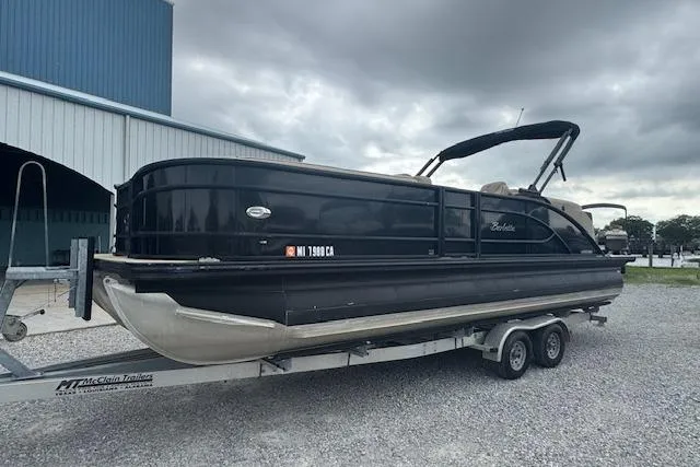 Slide: The Image of 2020 Barletta Lusso 25QCSS pontoon boat on trailer, parked outdoors under cloudy skies. - 9