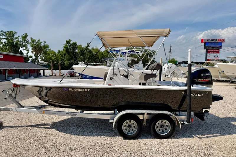 The Image of 2021 Tidewater 1910 Bay Max boat on trailer, parked outdoors under clear sky. - 0