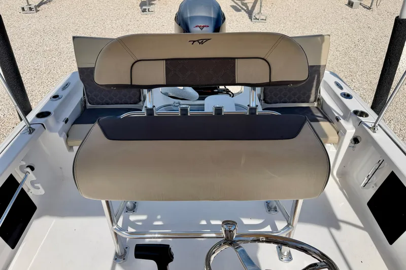 Slide: The Image of 2021 Tidewater 1910 Bay Max boat interior with cushioned seating and steering wheel. - 10