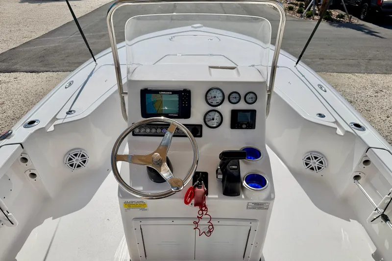 Slide: The Image of Center console of a 2021 Tidewater 1910 Bay Max boat with steering wheel and gauges. - 12