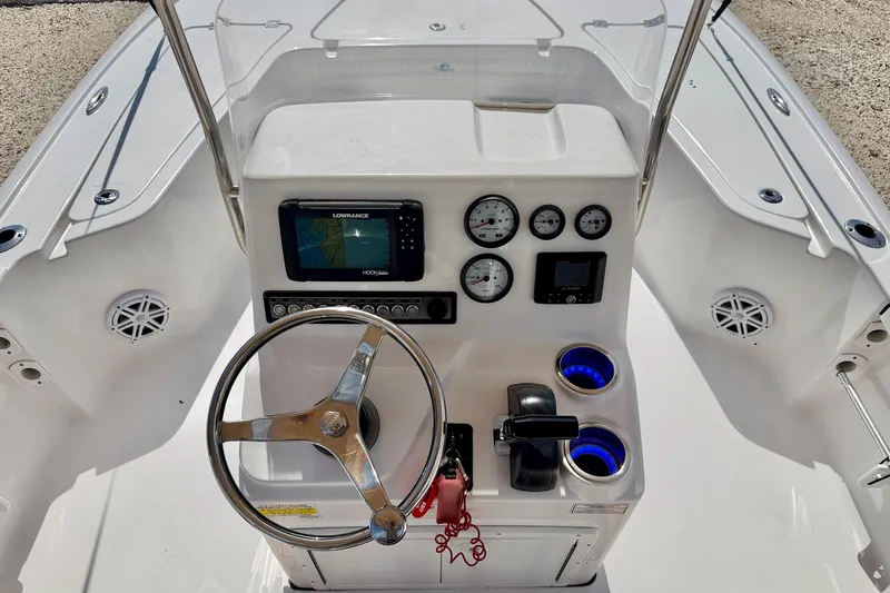 Slide: The Image of Center console of a 2021 Tidewater 1910 Bay Max boat with steering wheel and navigation system. - 13