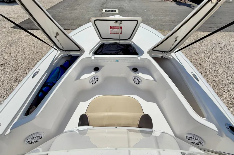 Slide: The Image of 2021 Tidewater 1910 Bay Max boat interior with open storage compartments and seating. - 22