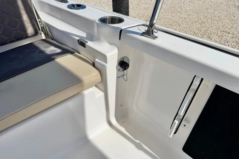 Slide: The Image of Interior view of a 2021 Tidewater 1910 Bay Max boat, featuring seating and cup holders. - 23