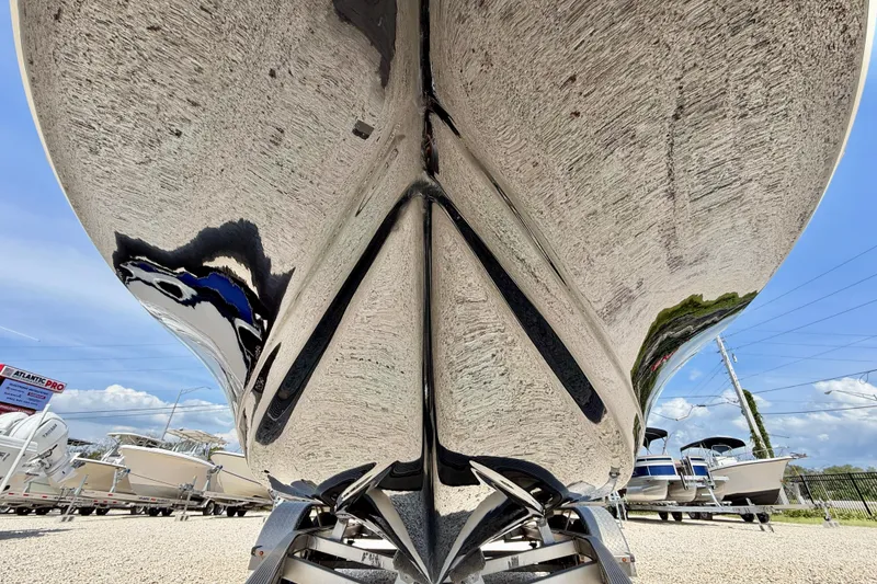 Slide: The Image of 2021 Tidewater 1910 Bay Max boat hull on trailer, reflecting sky and surroundings. - 30