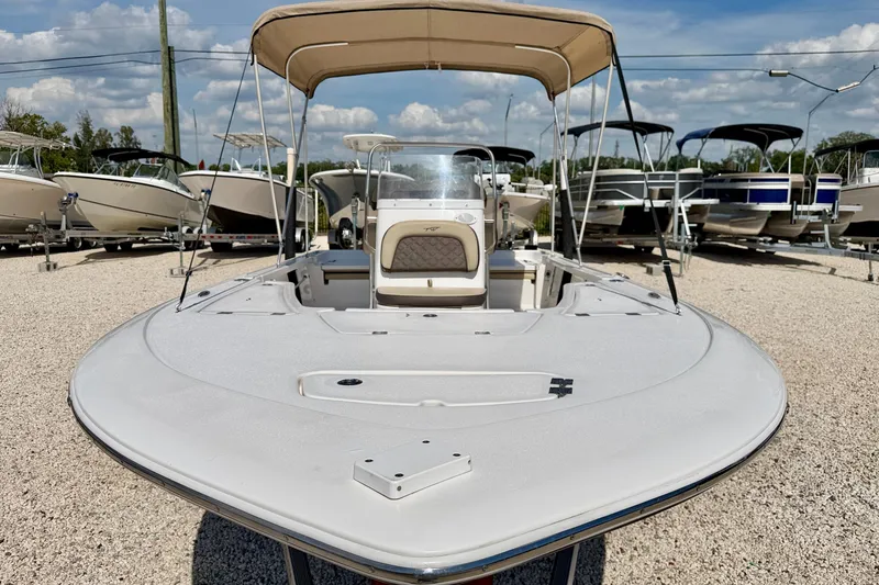 Slide: The Image of 2021 Tidewater 1910 Bay Max boat with canopy, displayed in a boatyard under a clear sky. - 8