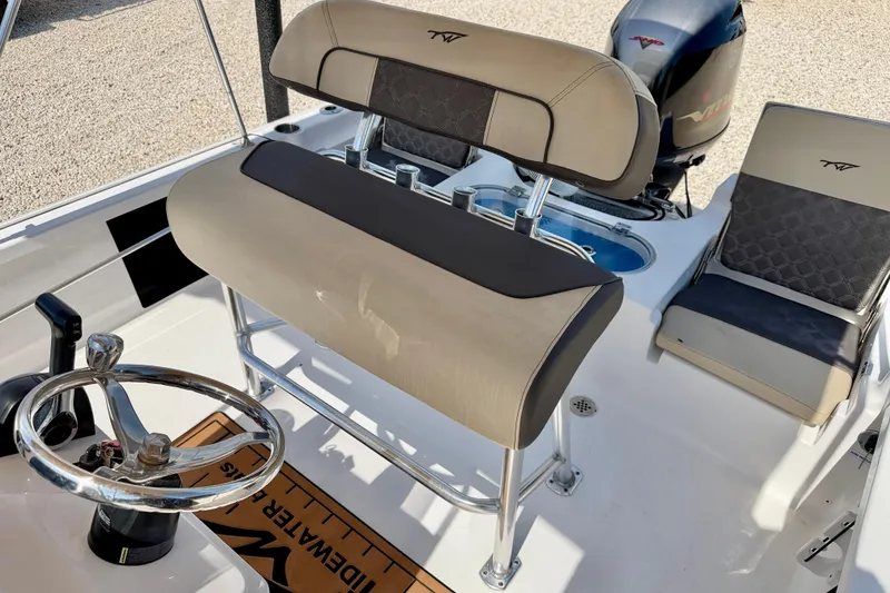 Slide: The Image of 2021 Tidewater 1910 Bay Max boat interior with steering wheel and seating. - 9