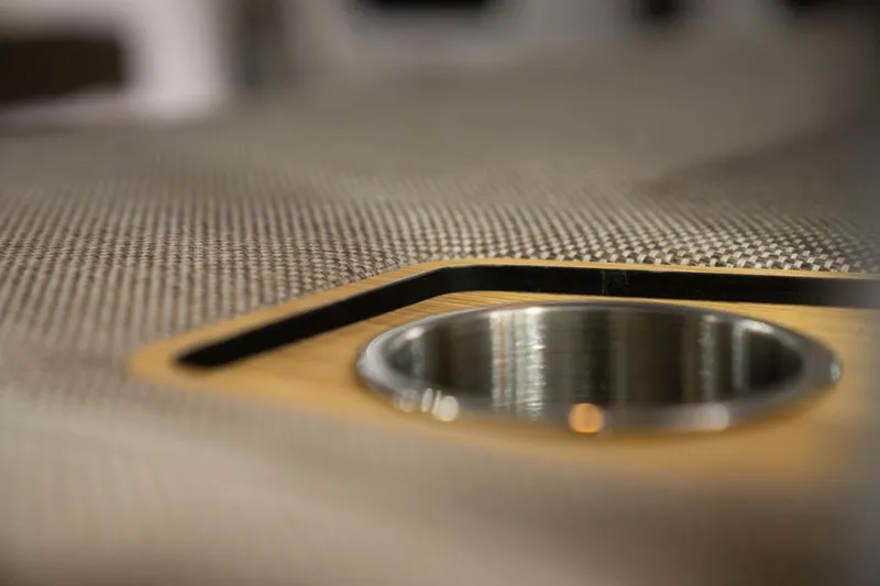 Slide: The Image of Close-up of a 2026 Axopar 29 Sun-Top boat's cup holder on a textured surface. - 10
