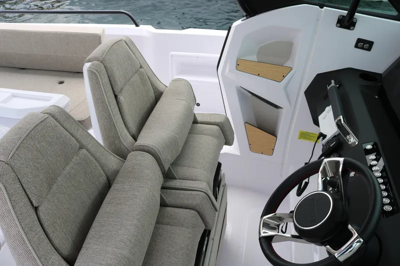 Slide: The Image of Interior of 2026 Axopar 29 Sun-Top boat with modern seating and steering wheel. - 16
