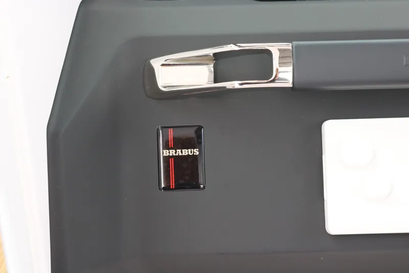 Slide: The Image of 2026 Axopar 29 Sun-Top boat detail with Brabus branding and sleek design elements. - 18