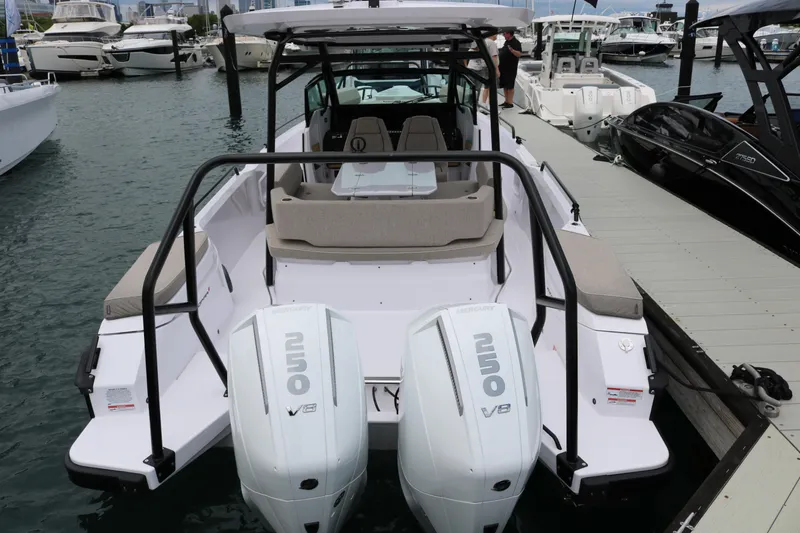 Slide: The Image of 2026 Axopar 29 Sun-Top boat docked, featuring dual Mercury 250 V8 engines. - 21