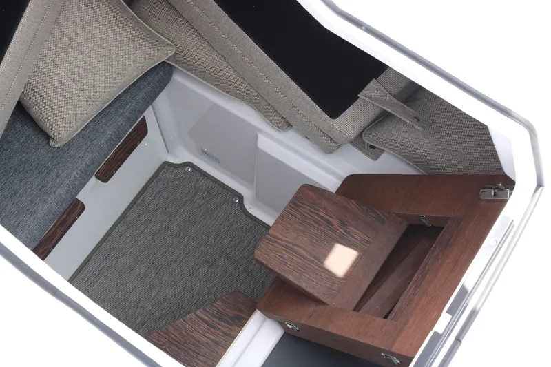 Slide: The Image of Interior cabin of 2026 Axopar 29 Sun-Top, featuring modern seating and wooden accents. - 24