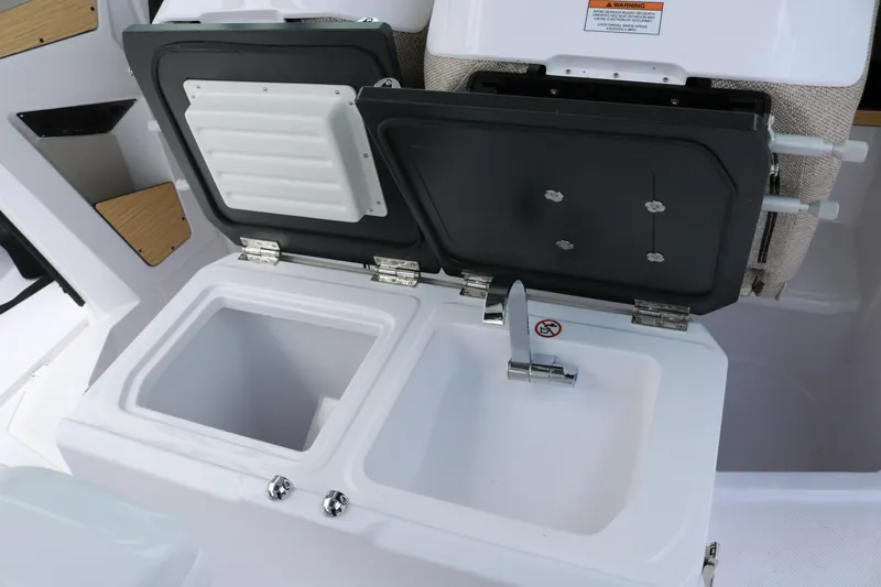 Slide: The Image of 2026 Axopar 29 Sun-Top boat sink and storage compartment detail. - 25