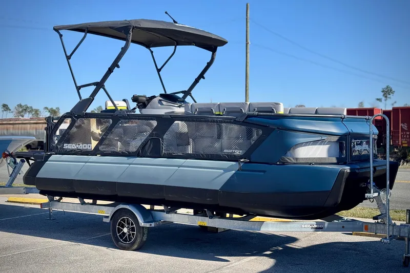 The Image of 2025 Sea-Doo Switch Cruise Limited 21 on trailer, parked outdoors under clear sky. - 0