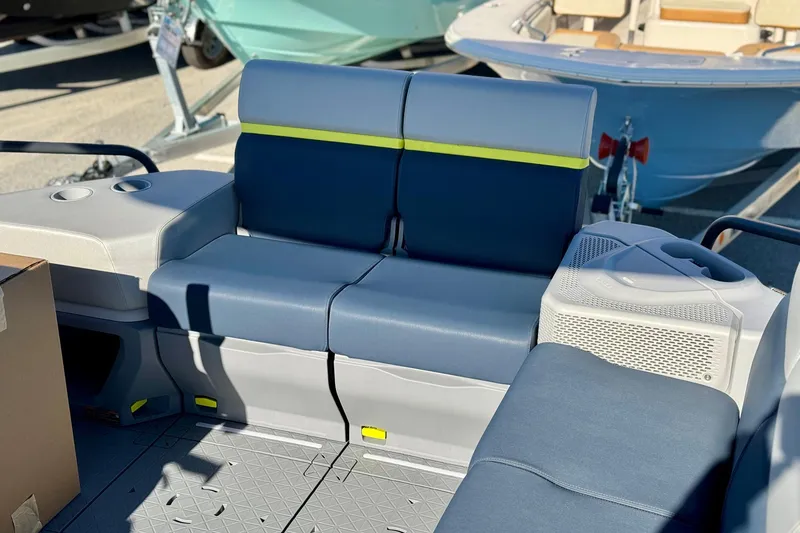 Slide: The Image of 2025 Sea-Doo Switch Cruise Limited 21 interior seating with blue upholstery and cup holders. - 11