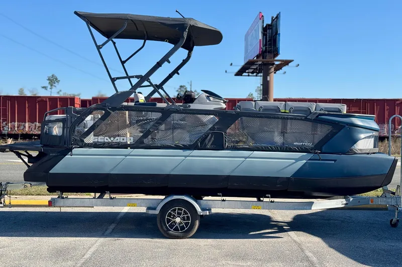 Slide: The Image of 2025 Sea-Doo Switch Cruise Limited 21 on trailer, featuring sleek design and canopy. - 16