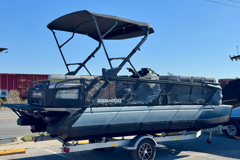 Slide: The Image of 2025 Sea-Doo Switch Cruise Limited 21 pontoon boat on trailer, outdoor setting. - 2