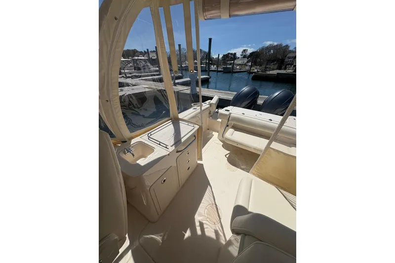 Slide: The Image of 2016 Grady-White Freedom 275 boat interior with seating and water view. - 10